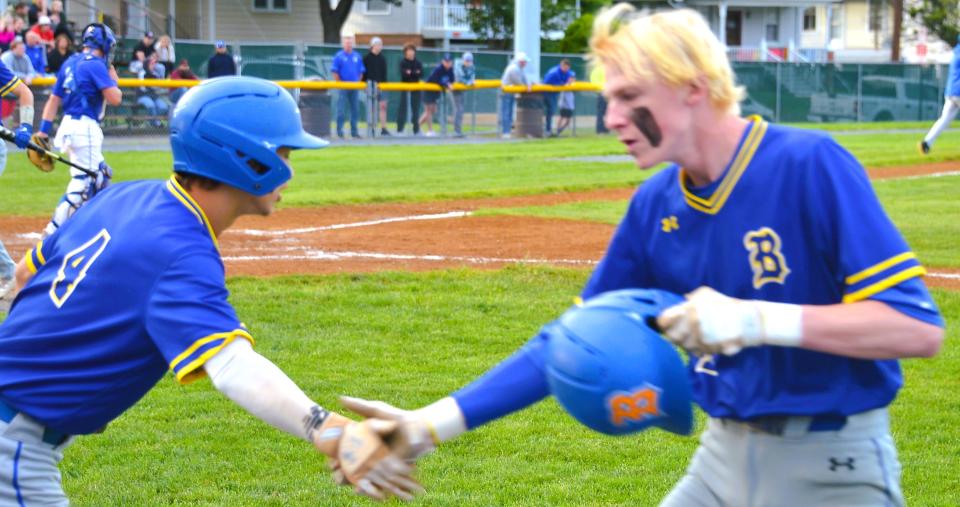 Clear Spring's Kannon Shives, right, gets a hand slap from Malakai Cunningham after laying down a sacrifice bunt in the first inning of the Blazers' 1-0 win over Allegany in the Class 1A semifinals.