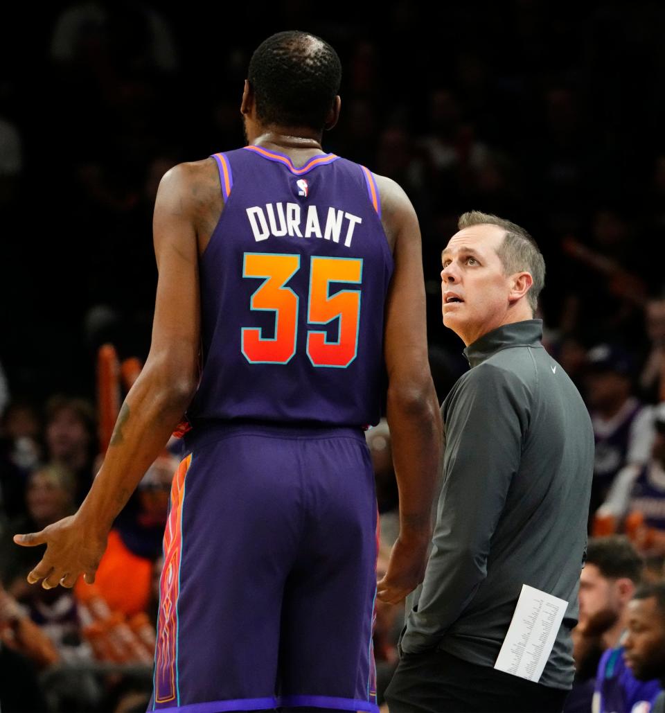 Phoenix Suns forward Kevin Durant (35) talks to head coach Frank Vogel against the Washington Wizards in the first half at Footprint Center in Phoenix on Dec. 17, 2023.