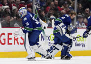 Vancouver Canucks goalie Spencer Martin (30) leaves the ice and is replaced by goalie Collin Delia (60) after giving up four goals to the Montreal Canadiens during the first period of an NHL hockey game in Vancouver, British Columbia, Monday, Dec. 5, 2022. (Darryl Dyck/The Canadian Press via AP)