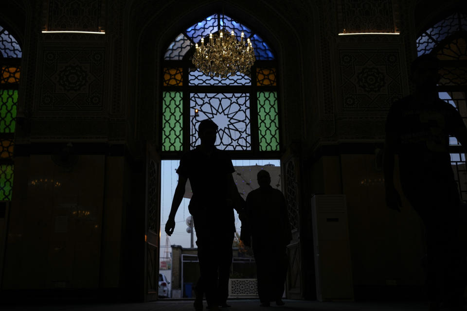 Muslim worshippers enter Abu Hanifa Mosque awaiting the announcement of the beginning of Ramadan, in Baghdad, Iraq, Sunday, March 10, 2024. Ramadan starts the day after moon sighting which marks the beginning of a new lunar month, most religious authorities in the Middle East declared Monday is the first day of the holy month of Ramadan, when observant Muslims fast from dawn to dusk. (AP Photo/ Hadi Mizban)