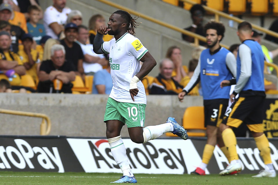 Newcastle United's Allan Saint-Maximin celebrates after scoring their side's first goal of the game during the Premier League match between Wolverhampton Wanderers and Newcastle United at the Molineux Stadium, Wolverhampton, Britain, Sunday Aug. 28, 2022. (Jacob King/PA via AP)