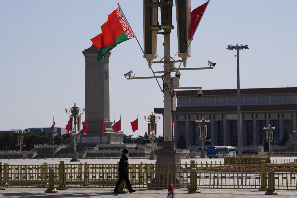 A Chinese policeman walks past the Belarusian flag on Tiananmen Square in Beijing, Wednesday, March 1, 2023. Belarusian President Alexander Lukashenko, a close ally of Russian leader Vladimir Putin, has arrived in Beijing on a three-day state visit. (AP Photo/Ng Han Guan)