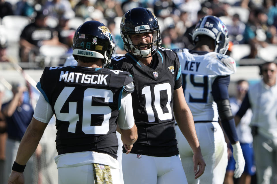 Jacksonville Jaguars long snapper Ross Matiscik (46) congratulates place-kicker Brandon McManus (10) after making a 25-yard field goal against the Tennessee Titans during the half of an NFL football game, Sunday, Nov. 19, 2023, in Jacksonville, Fla. (AP Photo/John Raoux)