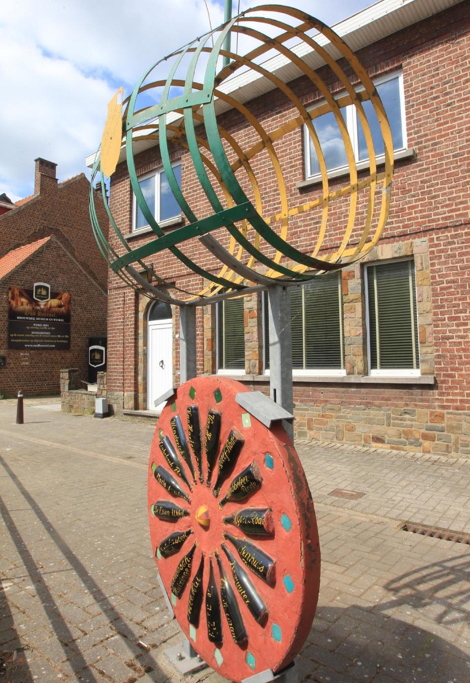 In this picture taken Tuesday April 15, 2014, bottles from breweries that stopped producing artisan Geuze beer are displayed in an art work in front of one of the last remaining authentic lambic breweries 'Oud Beersel', in Beersel, South of Brussels. Thousands of bars in town and villages have closed over the past decades, and on top of it, Belgians have stopped drinking like they used to. The Belgian beer federation is now trying to rekindle local faith in the drink with a 'Proud of Belgian Beers' campaign. (AP Photo/Yves Logghe)