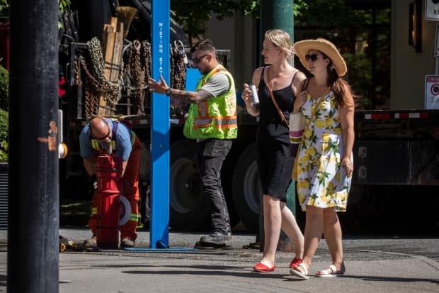City of Vancouver workers install a misting station due to the heat wave in Vancouver, British Columbia on Friday, June 25, 2021.  (Ben Nelms/CBC - image credit)