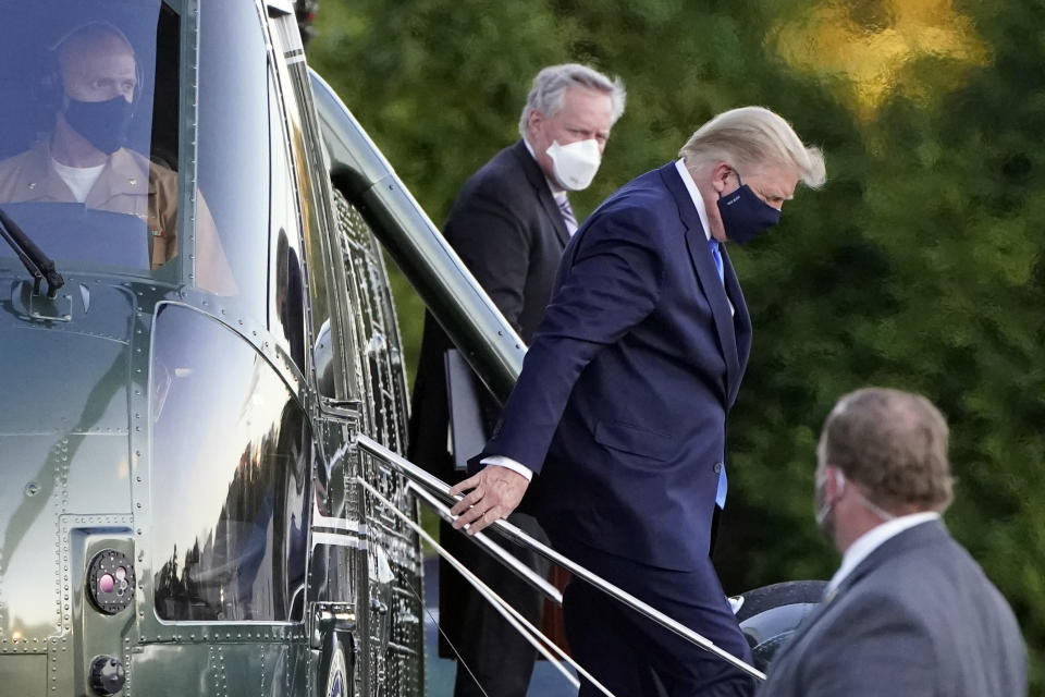 FILE - In this Friday, Oct. 2, 2020, file photo, President Donald Trump steps down from Marine One as he arrives at Walter Reed National Military Medical Center in Bethesda, Md., after he tested positive for COVID-19. White House chief of staff Mark Meadows is in the background. The president’s coronavirus infection, as well as the illnesses of several aides and allies, has imperiled the highest levels of the U.S. government. The White House’s efforts Saturday to project calm backfired in stunning fashion, resulting in a blizzard of confusing and contradictory information about the health and well-being of the commander in chief. (AP Photo/Jacquelyn Martin, File)