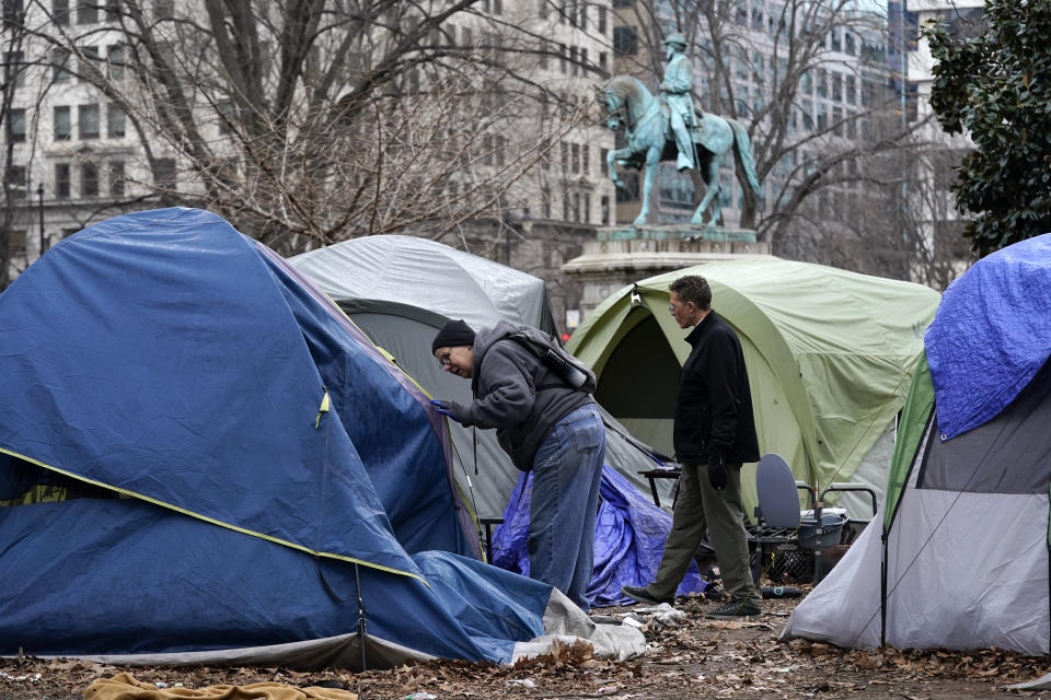 Homeless advocates check inside tents at McPherson Square in Washington, Wednesday, Feb. 15, 2023, prior to a clearing of a homeless encampment by the National Park Service. (AP Photo/Patrick Semansky)
