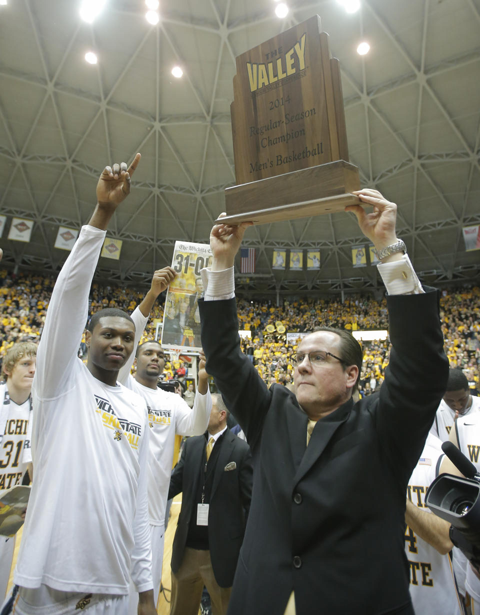 Wichita State coach Gregg Marshall holds up the Missouri Valley Conference regular season trophy after beating Missouri State 68-45 in an NCAA college basketball game in Wichita, Kansas., Saturday, March 1, 2014. (AP Photo/The Wichita Eagle, Travis Heying) LCOAL TV OUT; MAGS OUT; LOCAL RADIO OUT; LOCAL INTERNET OUT