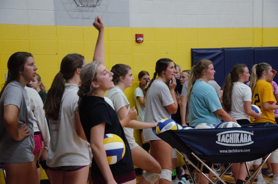 Girls trying out for the girls volleyball team watch as other players serve during tryouts on Tuesday, August 8.