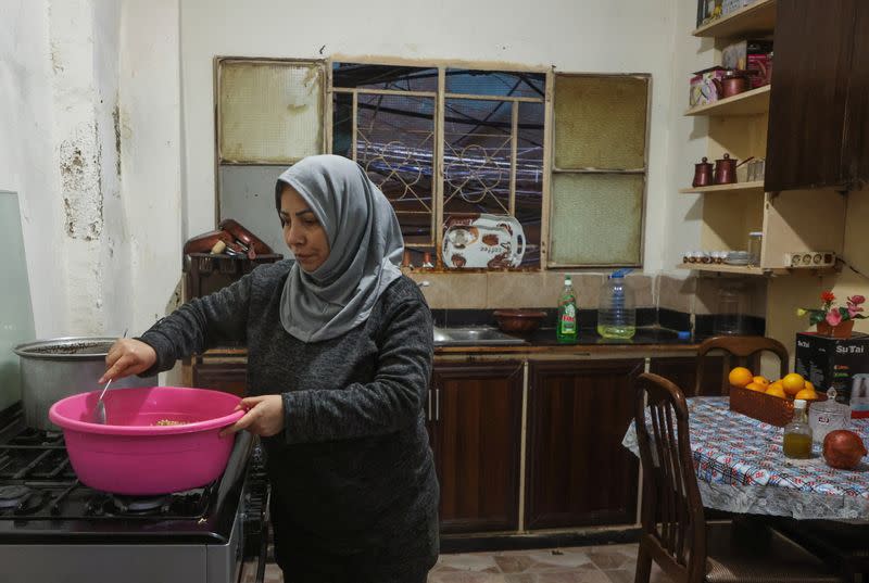 A Palestinian refugee, Raghida al-Arbaje, works at her kitchen at Burj al-Barajneh refugee camp in Beirut