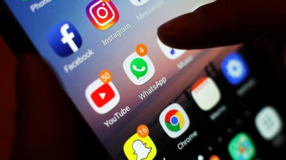 A stock photo shows social media apps on the home screen of a smartphone