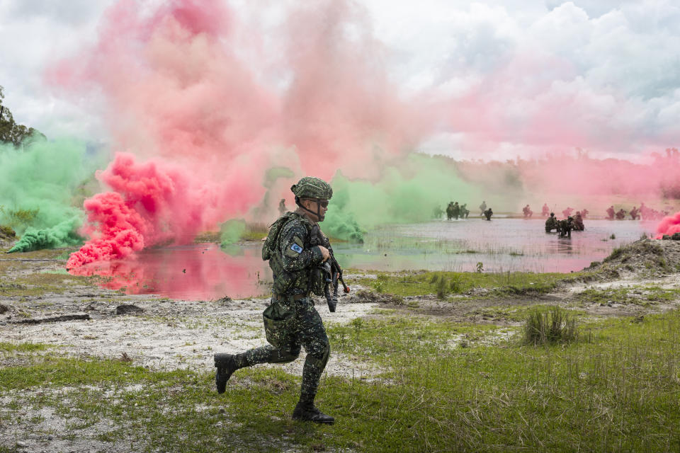 In this photo released by Australian Department of Defense via Australian Embassy in the Philippines, an Armed Forces of the Philippines soldier moves firing positions during a large-scale combined amphibious assault exercise on Friday, Aug. 25, 2023, at a naval base in San Antonio, Zambales, Philippines. The Philippines and Australia, while also backed by the United States Marine Corps, are holding a bilateral amphibious training called "Exercise Alon 2023," coined from Tagalog word meaning "wave," which is aimed at enhancing interoperability and preparedness to respond to security challenges in the Indo-Pacific region. (Riley Blennerhassett/Australian Department of Defense via AP)