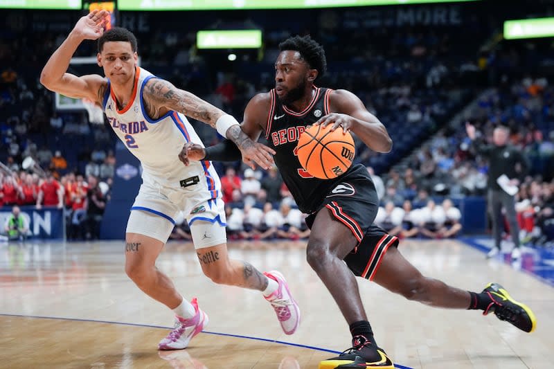 Georgia guard Noah Thomasson (3) drives against Florida guard Riley Kugel (2) during the first half of an NCAA college basketball game at the Southeastern Conference tournament Thursday, March 14, 2024, in Nashville, Tenn. | John Bazemore