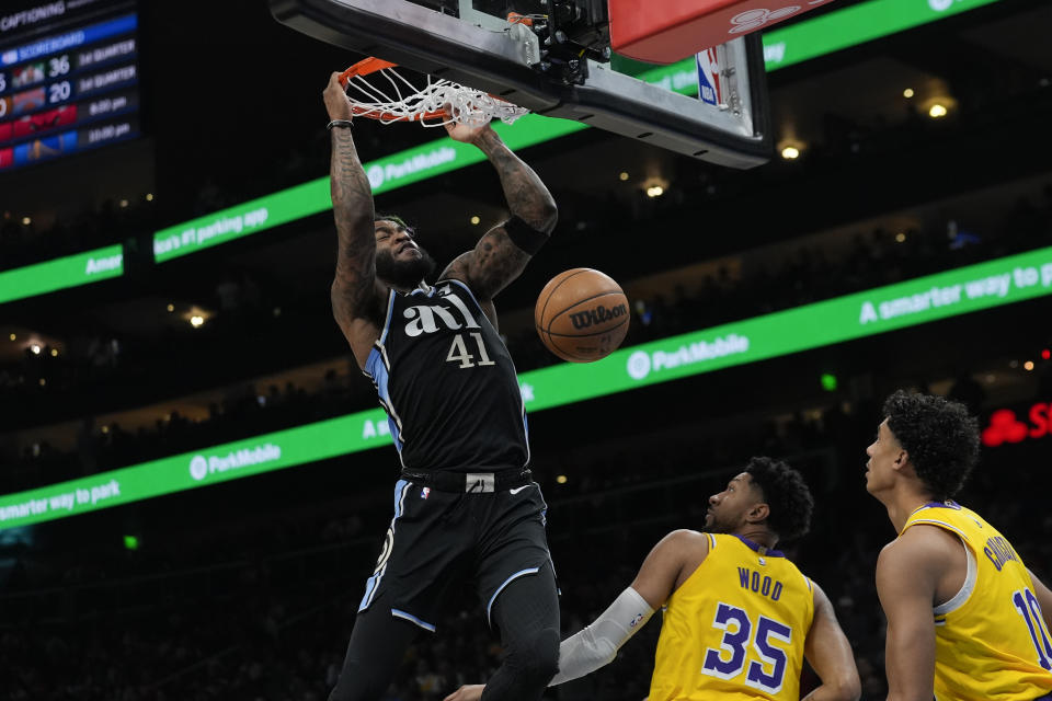 Atlanta Hawks forward Saddiq Bey (41) scores as Los Angeles Lakers Christian Wood (35) and Max Christie (10) defend in the half of an NBA basketball game Tuesday, Jan. 30, 2024, in Atlanta. (AP Photo/John Bazemore)