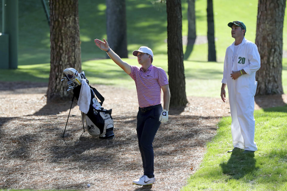 John Augenstein looks over his third shot with caddie William Kane on the 7th hole during the second round of the Masters Friday, Nov. 13, 2020, in Augusta, Ga. (Curtis Compton/Atlanta Journal-Constitution via AP)