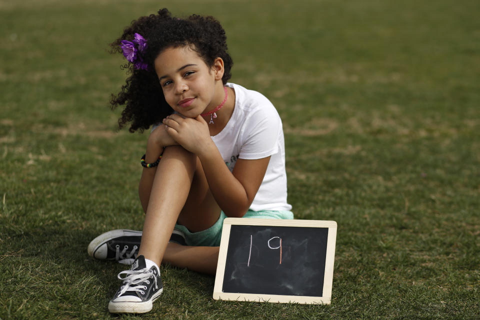 Havana Chapman-Edwards, 8, of Washington, sits by a chalkboard with her age in 2030, the point where the globe would be stuck on a path toward what scientists call planet-changing dangerous warming, Friday, March 15, 2019, during a climate change rally of students in Washington. "Borders, languages and religions do not separate us," Chapman-Edwards, who calls herself the tiny diplomat, said at the U.S. Capitol. "Today we are telling the truth and we do not take no for an answer." From the South Pacific to the edge of the Arctic Circle, students are skipping classes to protest what they see as the failures of their governments to take tough action against global warming. The 'school strikes' on Friday were inspired by 16-year-old Swedish activist Greta Thunberg and are taking place in over 100 countries. (AP Photo/Jacquelyn Martin)