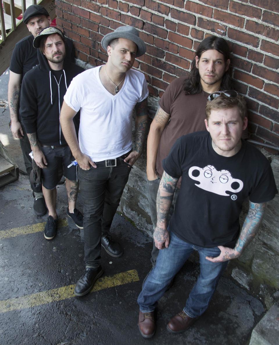 FILE - In this July 18, 2012 file photo, from right, Brian Fallon, Benny Horowitz, Alex Levine, Alex Rosamilia, and Ian Perkins, of the musical group, The Gaslight Anthem, pose for a portrait at the Cannery Ballroom, in Nashville, Tenn. The band relocated to Nashville in February 2012 and hooked up with Grammy-winning producer, Brendan O'Brien, at Blackbird Studios, to work on their new album, "Handwritten." (Photo by Ed Rode/Invision/AP, File)