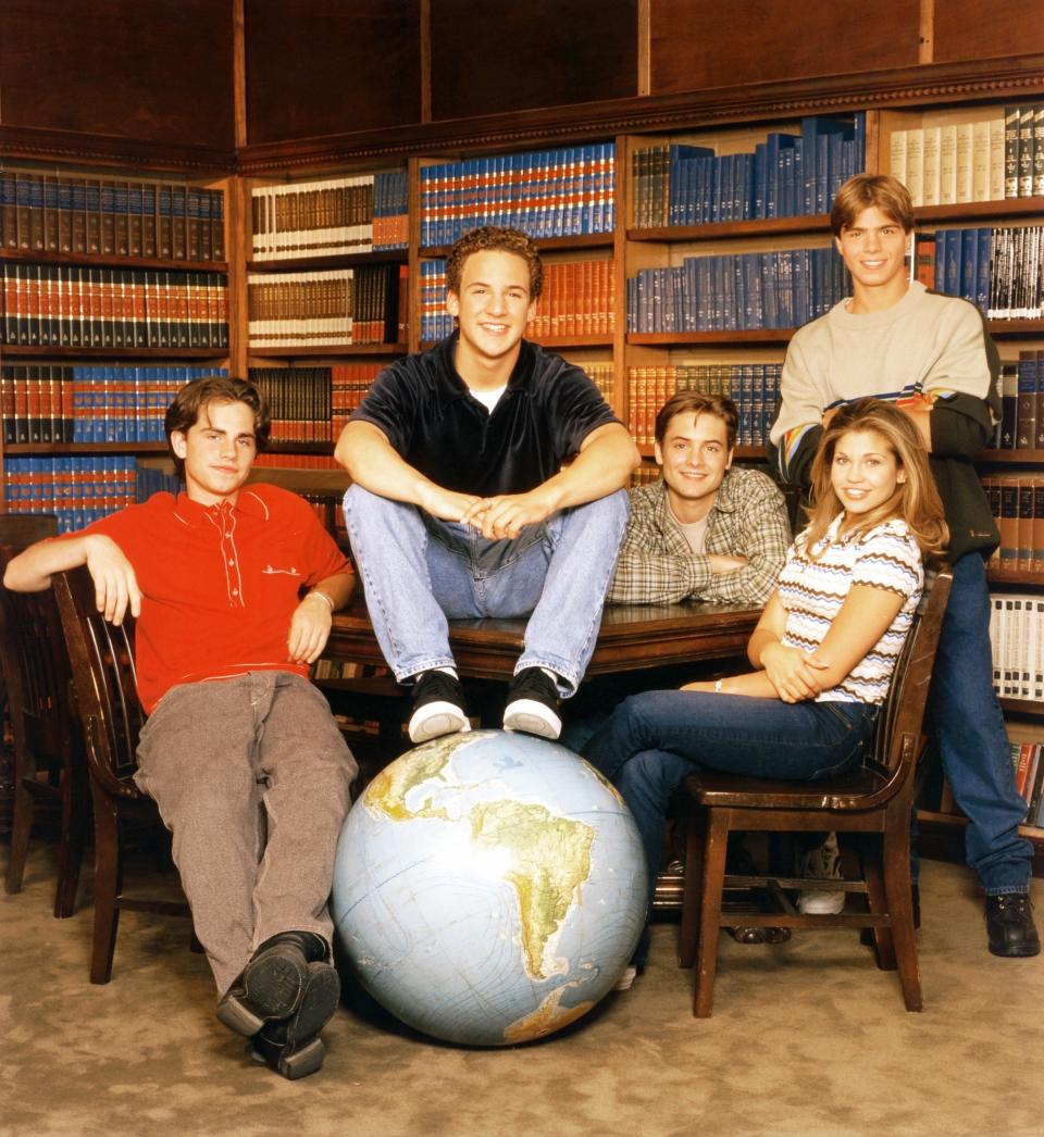 The cast of "Boy Meets World" poses in a library