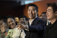 Thailand's Future Forward Party leader Thanathorn Juangroongruangkit, center, talks to reporters during a press conference at the party's headquarters in Bangkok, Thailand, Tuesday, Jan. 21, 2020. Thailand's Constitutional Court acquitted the country's third-biggest political party of seeking the overthrow of the country's constitutional monarchy. The court ruled Tuesday that the Future Forward Party showed no intention of committing the offense, and that the complaint had not been filed according to the correct legal procedure. (AP Photo/Sakchai Lalit)