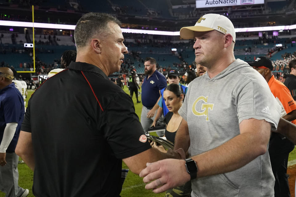 Miami head coach Mario Cristobal, left, and Georgia Tech head coach Brent Key congratulate each other after an NCAA college football game, Saturday, Oct. 7, 2023, in Miami Gardens, Fla. (AP Photo/Wilfredo Lee)