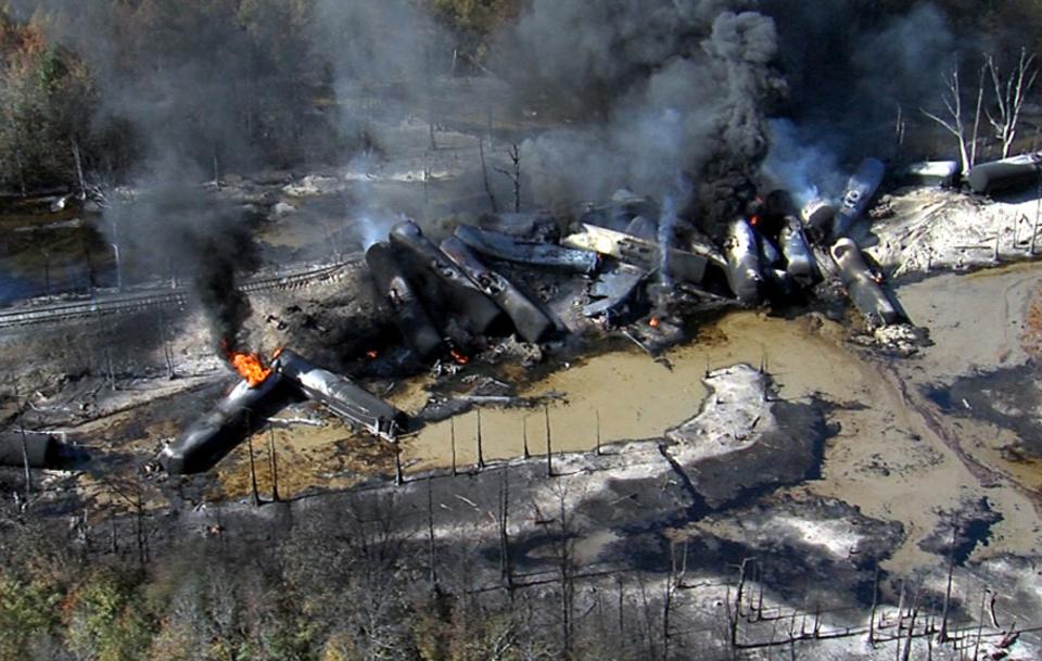 Smoke rises from a number of cars that derailed and exploded from a train carrying crude oil in Aliceville