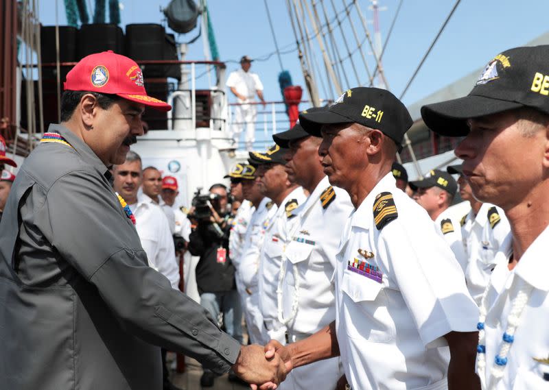 FILE PHOTO: Venezuela's President Nicolas Maduro shakes hands with an officer of the Simon Bolivar training ship, Venezuelan navy's flagship, in La Guaira