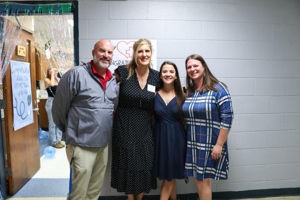 West Henderson High teacher Kelly Stepp poses assistant principals Justin Heatherly, Emily Young and Whitney Ashbrook after Stepp was named the 2024 Henderson County Public Schools Teacher of the Year.