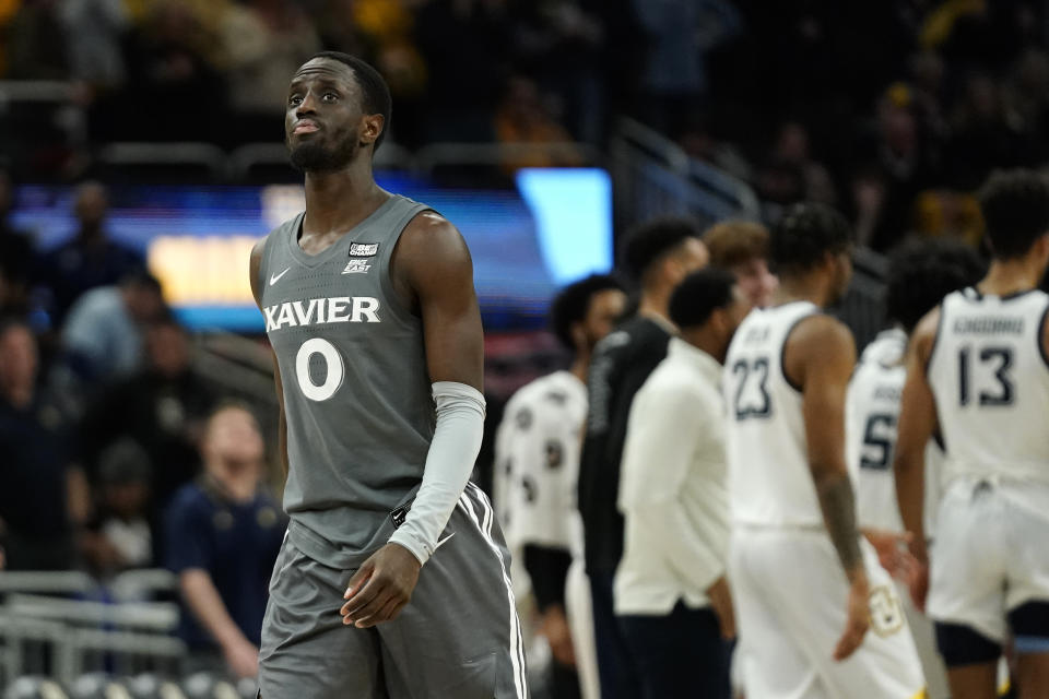 Xavier's Souley Boum (0) reacts as he walks to the bench during the second half of an NCAA college basketball game against Marquette Wednesday, Feb. 15, 2023, in Milwaukee. (AP Photo/Aaron Gash)