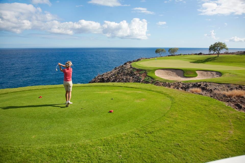 Woman golfing on The Challenge at Manele Golf Course on Lanai, Hawaii