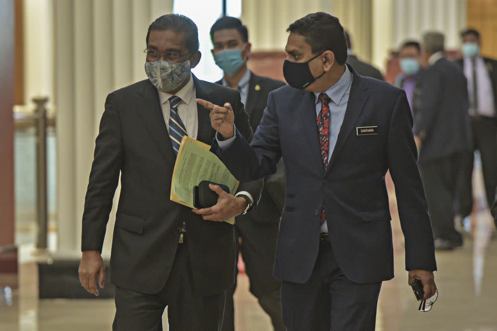 Minister in the Prime Minister's Department Datuk Takiyuddin Hassan (left) is pictured in Parliament Kuala Lumpur August 27, 2020. — Picture by Shafwan Zaidon