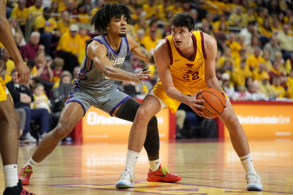 Iowa State forward Milan Momcilovic (22) looks to pass around TCU guard Micah Peavy, left, during the first half of an NCAA college basketball game, Saturday, Feb. 10, 2024, in Ames, Iowa. (AP Photo/Charlie Neibergall)