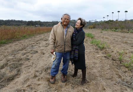 Farmer Tom Chino (L) poses for a photograph with chef, author and restaurateur Alice Waters, at his family's farm in Rancho Santa Fe, California December 7, 2013. REUTERS/Mike Blake