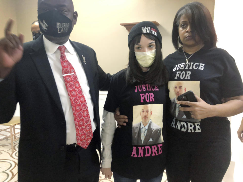 Attorney Benjamin Crump, left, discusses the police shooting of Andre Hill at a news conference attended by Hill's daughter, Karissa, center, and sister Shawna Barnett, on Thursday, Dec. 31, 2020, in Columbus, Ohio. Karissa Hill said she considered her father an "everything man" because he did so many things. (AP Photo/Andrew Welsh-Huggins)