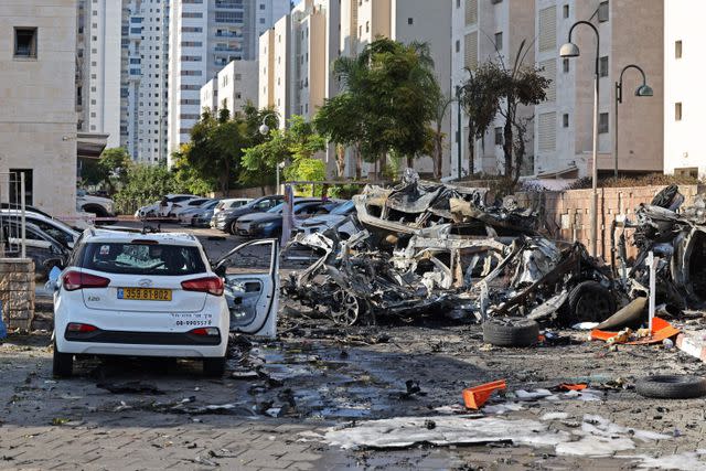 <p>AHMAD GHARABLI/AFP via Getty</p> Burnt out vehicles in Ashkelon, Israel, after Hamas rockets launched an attack on Oct. 7, 2023