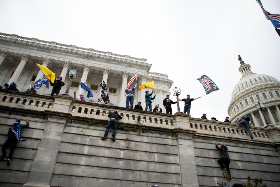 In this Wednesday, Jan. 6, 2021, file photo, supporters of President Donald Trump climb the west wall of the the U.S. Capitol on in Washington. Lies, misinformation and conspiracy theories related to the 2020 election are gaining traction among local, county and state Republicans, who are using their online platforms to disseminate many of the same dangerous messages that led to the violent insurrection at the Capitol last month. (AP Photo/Jose Luis Magana)