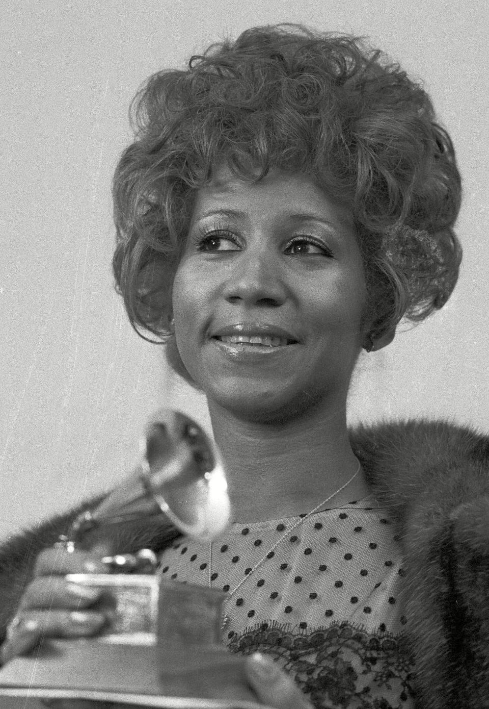 <p>Aretha Franklin holds her Grammy Award for Best Rhythm and Blue performance of the song “Bridge Over Troubled Waters,” in 1972. (PA) </p>