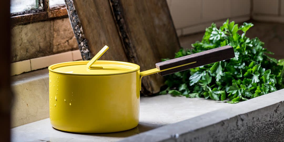 a yellow saucepan next to a window