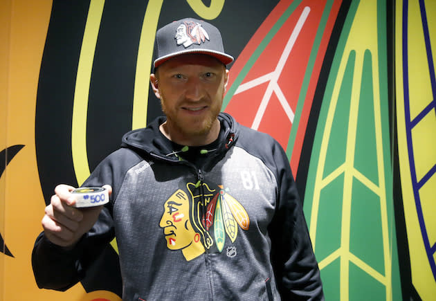 Chicago Blackhawks right wing Marian Hossa poses with his 500th career goal puck after an NHL hockey game against Philadelphia Flyers Tuesday, Oct. 18, 2016, in Chicago. The Blackhawks won 7-4. (AP Photo/Charles Rex Arbogast)