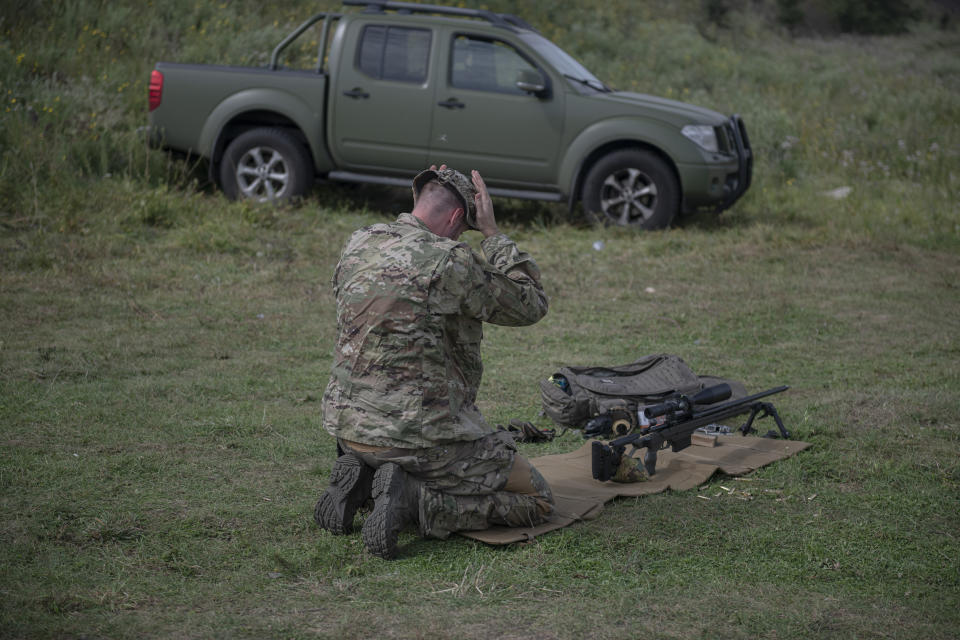 Ukrainian sniper Andriy attends a training outside of Kyiv, Ukraine, Saturday, Aug. 27, 2022. After moving to Western Europe to work an an engineer, Andriy scrambled back to Ukraine at the start of the war, and within weeks underwent a conversion from civilian life to a sniper being trained by the country's special forces. (AP Photo/Andrew Kravchenko)