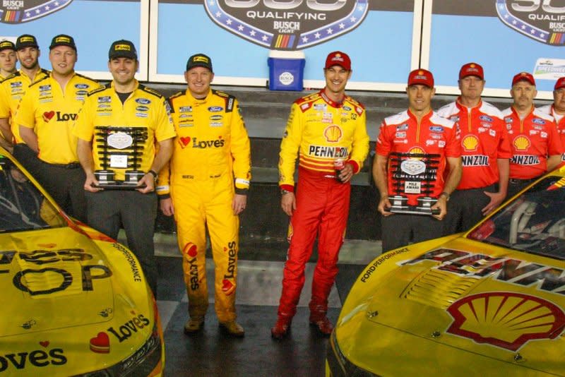 Michael McDowell (L) and pole winner Joey Logano (R) pose after qualifying for the 66th Daytona 500 on Wednesday in Daytona Beach, Fla. Photo by Mike Gentry/UPI