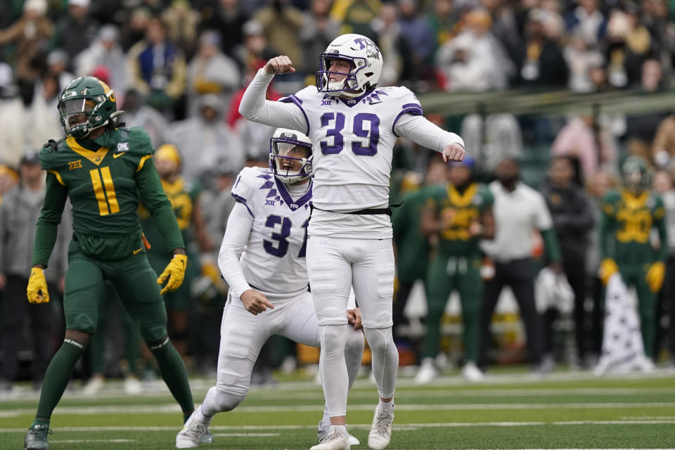 TCU place kicker Griffin Kell (39) reacts to scoring a field goal with teammate Jordy Sandy (31) as Baylor cornerback Lorando Johnson (11) looks on in the final seconds of an NCAA college football game in Waco, Texas, Saturday, Nov. 19, 2022. TCU won 29-28. (AP Photo/LM Otero)