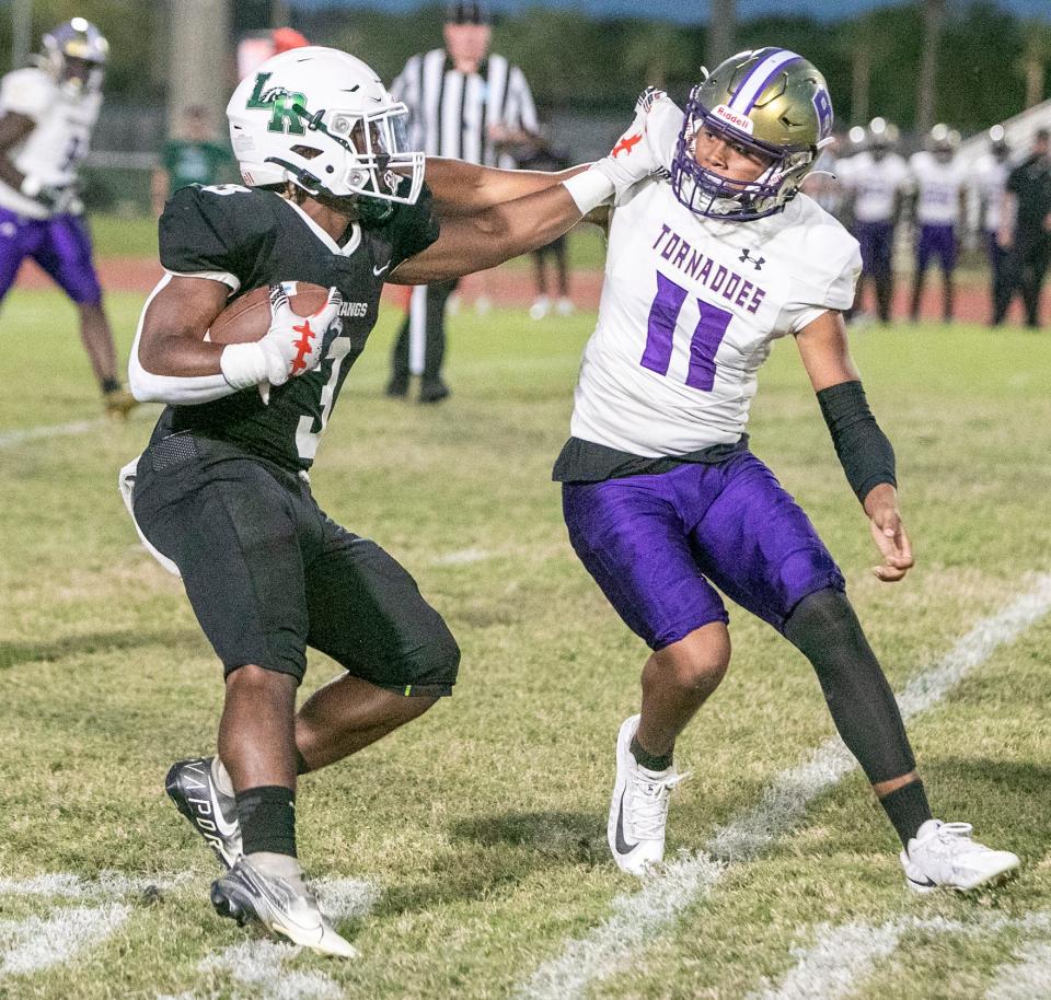 Lakewood Ranch running back Kevin Everhart (3) tries to run upfield  against Booker linebacker Dajien Walton (11) during their teams matchup in Lakewood Ranch.  MATT HOUSTON/HERALD-TRIBUNE