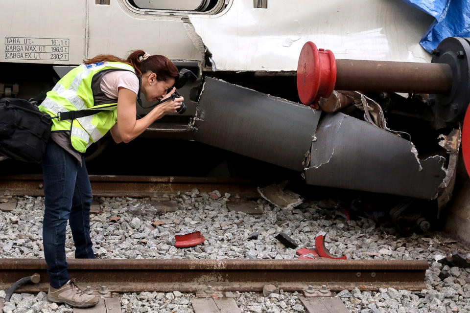 A technician photographs the damage