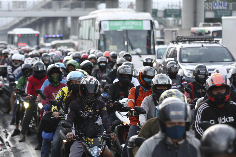 Motorists queue at a checkpoint during a stricter lockdown as a precaution against the spread of the new coronavirus disease at the outskirts of Marikina City, Philippines on Friday, August 6, 2021. Thousands of people jammed coronavirus vaccination centers in the Philippine capital, defying social distancing restrictions, after false news spread that unvaccinated residents would be deprived of cash aid or barred from leaving home during a two-week lockdown that started Friday. (AP Photo/Basilio Sepe)