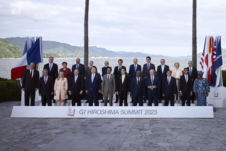 World leaders from G7 and invited countries, top row from left to right, Mathias Cormann, Secretary-General of the Organisation for Economic Co-operation and Development (OECD), Managing Director of the IMF Kristalina Georgieva, European Council President Charles Michel, German Chancellor Olaf Scholz, India's Prime Minister Narendra Modi, France's President Emmanuel Macron, U.S. President Joe Biden, Canada's Prime Minister Justin Trudeau, Australia's Prime Minister Anthony Albanese, European Commission President Ursula von der Leyen, Executive Director of the International Energy Agency Fatih Birol. Bottom row from left to right, President of the World Bank David Malpass, Secretary-General of the United Nations Antonio Guterres, Italy's Prime Minister Giorgia Meloni, Cook Islands Prime Minister Mark Brown, South Korea's Yoon Suk Yeol, Indonesia's President Joko Widodo, Japan's Prime Minister Fumio Kishida, Comoros President Azali Assoumani, Brazil's President Luiz Inacio Lula de Silva, Vietnam's Prime Minister Pham Minh Chinh, Britain's Prime Minister Rishi Sunak, and Director-General of the World Trade Organization Ngozi Okonjo-Iweala pose for a family photo of leaders of the G7 and invited countries during the G7 Leaders' Summit in Hiroshima western Japan, Saturday, May 20, 2023. (Brendan Smialowski/Pool Photo via AP)