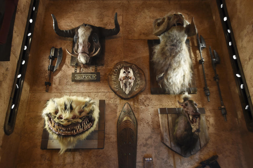 The heads of creatures from various "Star Wars" films are mounted on the wall of the Dok-Ondar's Den of Antiquities store during the Star Wars: Galaxy's Edge Media Preview at Disneyland Park, Wednesday, May 29, 2019, in Anaheim, Calif. (Photo by Chris Pizzello/Invision/AP)