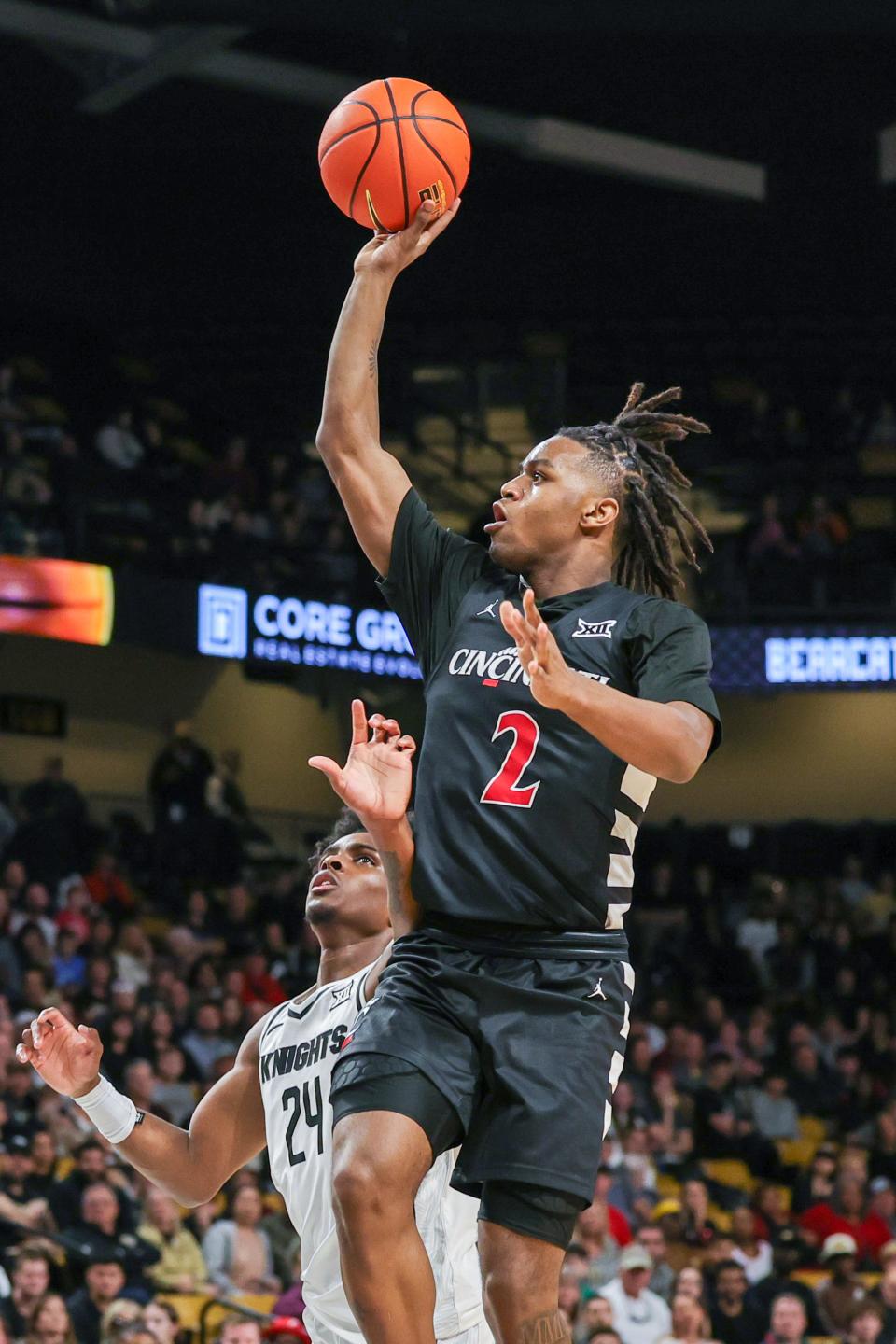 Feb 17, 2024; Orlando, Florida, USA; Cincinnati Bearcats guard Jizzle James (2) shoots the ball against UCF Knights guard Jaylin Sellers (24) during the first half at Addition Financial Arena. Mandatory Credit: Mike Watters-USA TODAY Sports