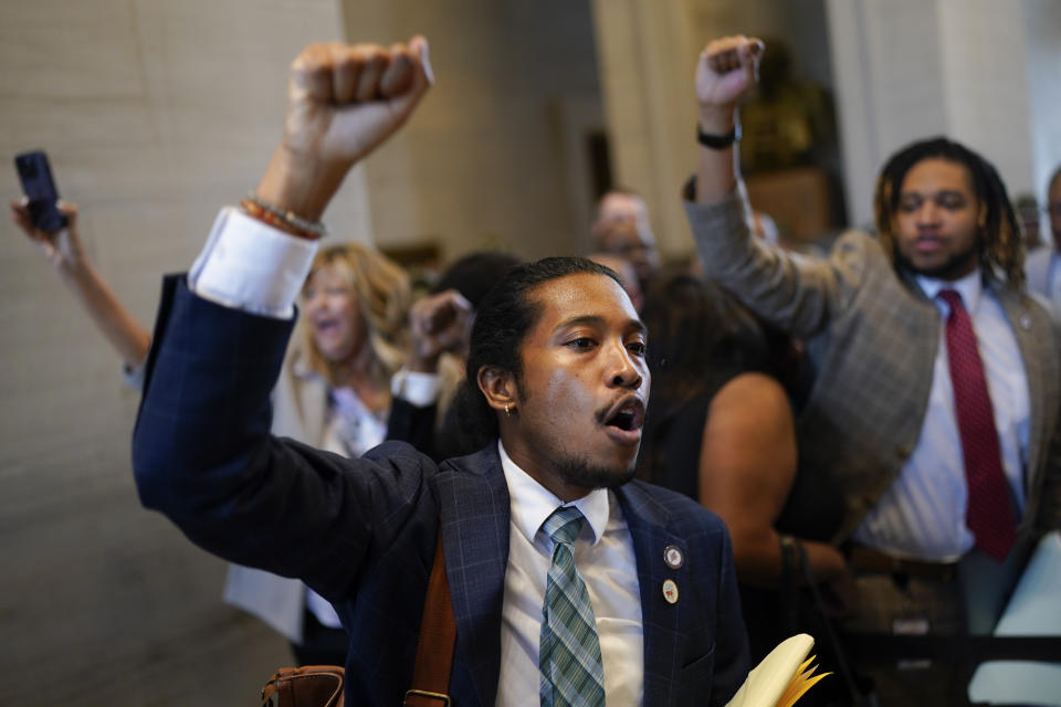 Rep. Justin Jones, D-Nashville, raises his fist to supporters outside the House chamber during a special session of the state legislature on public safety Monday, Aug. 28, 2023, in Nashville, Tenn. Jones was silenced for the remainder of the day by a floor vote after he was twice ruled out of order by the House Speaker. (AP Photo/George Walker IV)