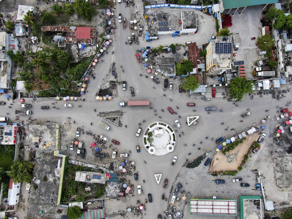 Vehicles drive through a roundabout in Les Cayes, Haiti, Wednesday, Aug. 19, 2021, five days after the city was struck by a 7.2-magnitude earthquake. (AP Photo/Fernando Llano)