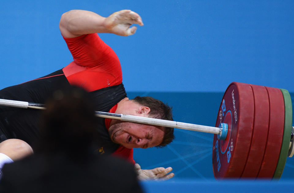 LONDON, ENGLAND - AUGUST 07: Matthias Steiner of Germany lies on the floor after failing to lift in the Men's +105kg Weightlifting final on Day 11 of the London 2012 Olympic Games at ExCeL on August 7, 2012 in London, England. (Photo by Lars Baron/Getty Images)